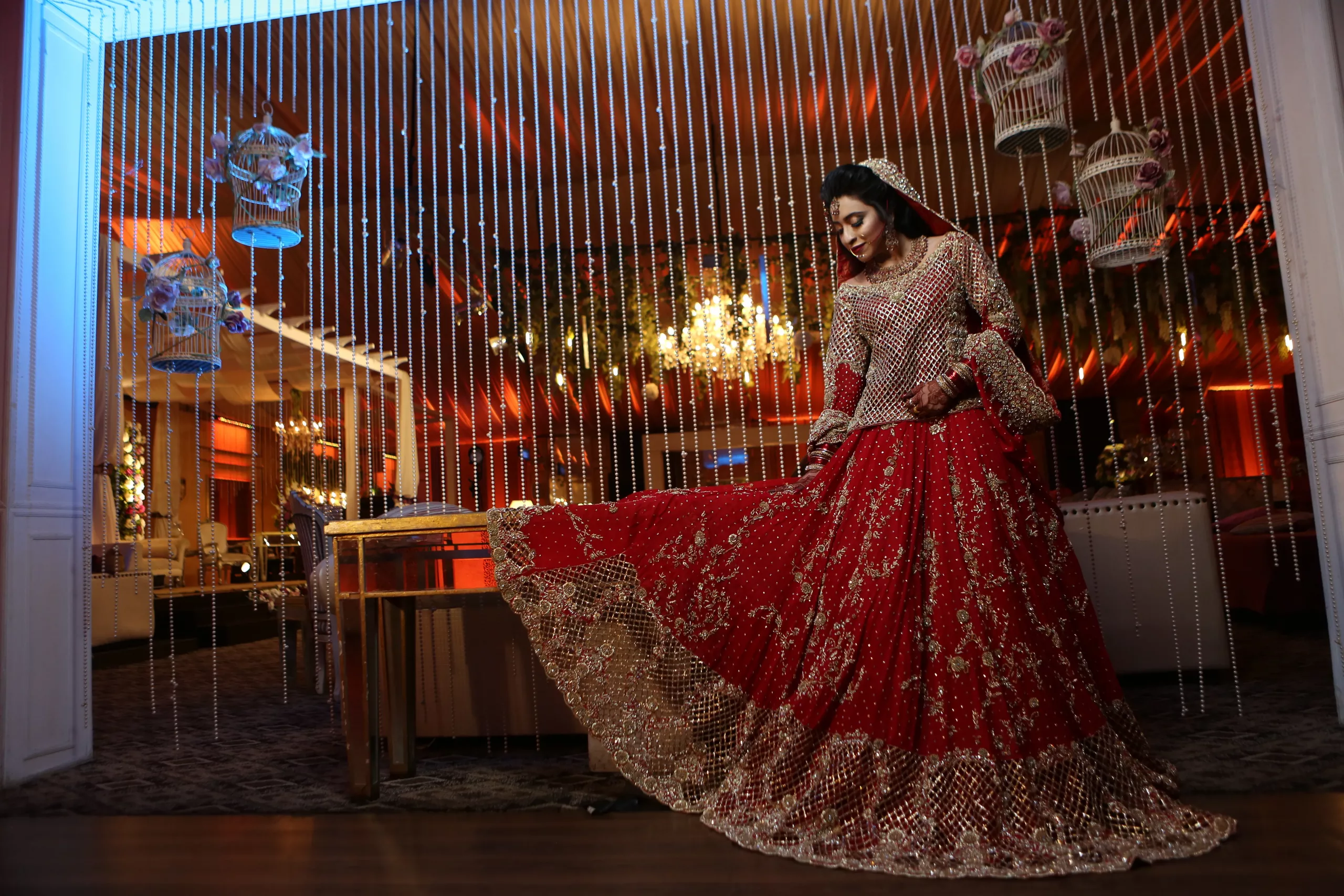 Beautiful Bride Wearing Red Heavy Dress Sitting on a Table